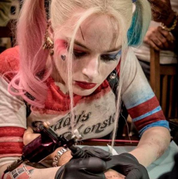 Margot Robbie giving tattoo on the set of suicide squad